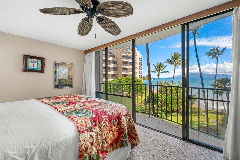 4327 Lower Honoapiilani Road, Unit 403 Lahaina, HI 96761 - Photo 2 of 42 a bedroom with a bed and a large window