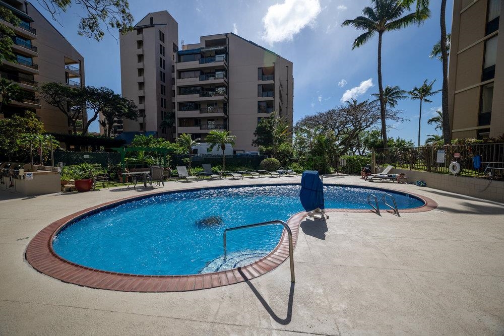 4327 Lower Honoapiilani Road, Unit 403 Lahaina, HI 96761 - Photo 28 of 42 a swimming pool with outdoor seating and yard