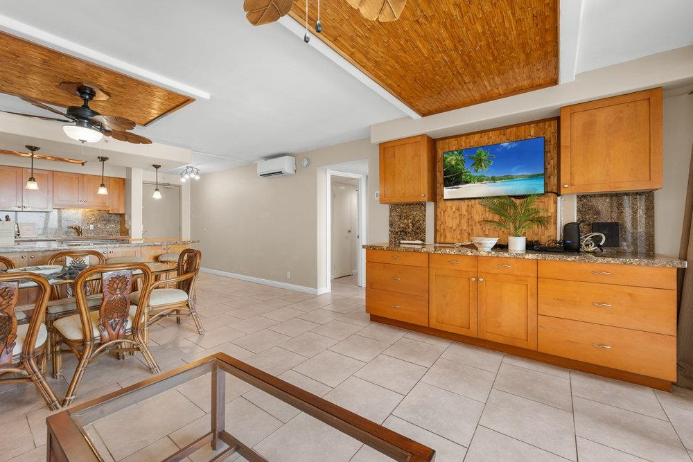4327 Lower Honoapiilani Road, Unit 403 Lahaina, HI 96761 - Photo 4 of 42 a kitchen with cabinets and chairs
