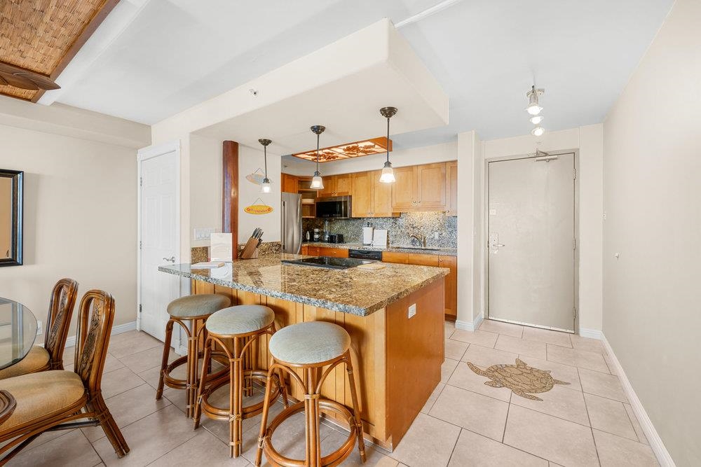 4327 Lower Honoapiilani Road, Unit 403 Lahaina, HI 96761 - Photo 7 of 42 a kitchen with stainless steel appliances granite countertop a sink and a refrigerator