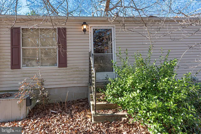 a dining room with a wooden table and chairs