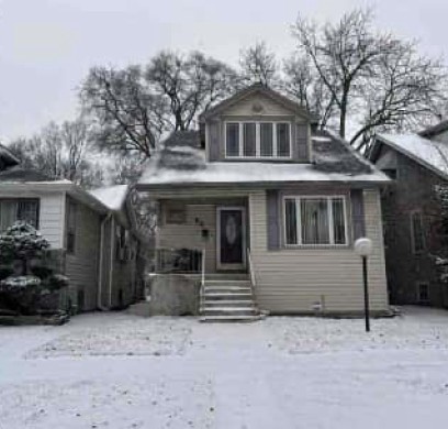 54 East 101st Street Chicago, IL 60628 - Photo 2 of 3 a front view of a house with a yard and garage