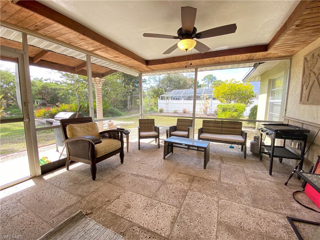 7558 Morgan Road Fort Myers, FL 33967 - Photo 5 of 25 a living room with patio furniture and a floor to ceiling window
