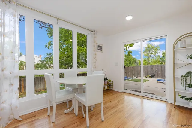 a dining room with wooden floor and a table