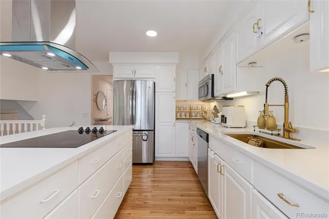 a kitchen with stainless steel appliances granite countertop a sink refrigerator and cabinets