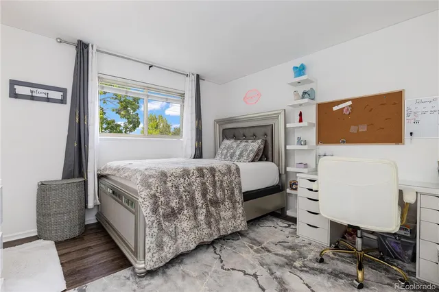 a bedroom with a bed and a desk