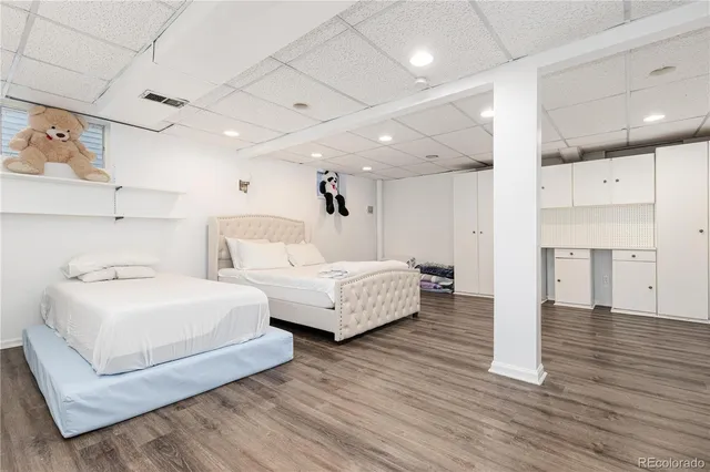 a spacious bedroom with two beds and a couch