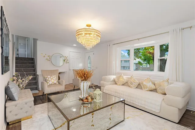 a living room with furniture chandelier and window