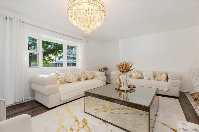 a living room with furniture and a chandelier