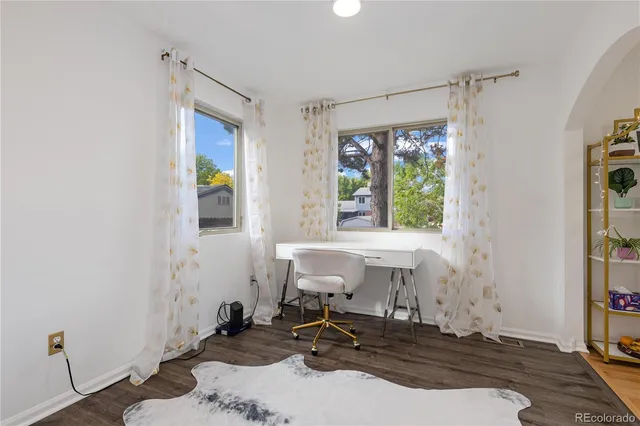 a view of a room with a window and wooden floor
