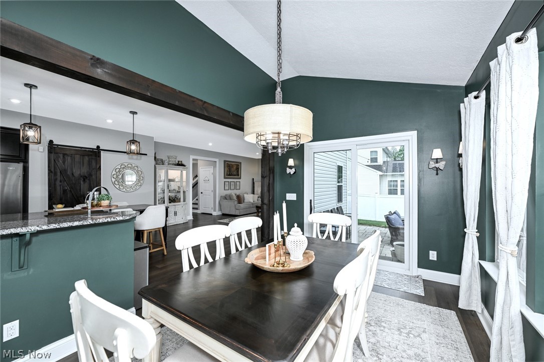 3021 Stonehurst Road Uniontown, OH 44685 - Photo 17 of 48 *MORNING ROOM W/WALLS OF WINDOWS, VAULTED CEILING, BEAMED ENTRY, CHANDELIER & ADDED SCONCE LIGHTING NEAR BREAKFAST BAR W/SLIDERS TO THE BACK YARD ~