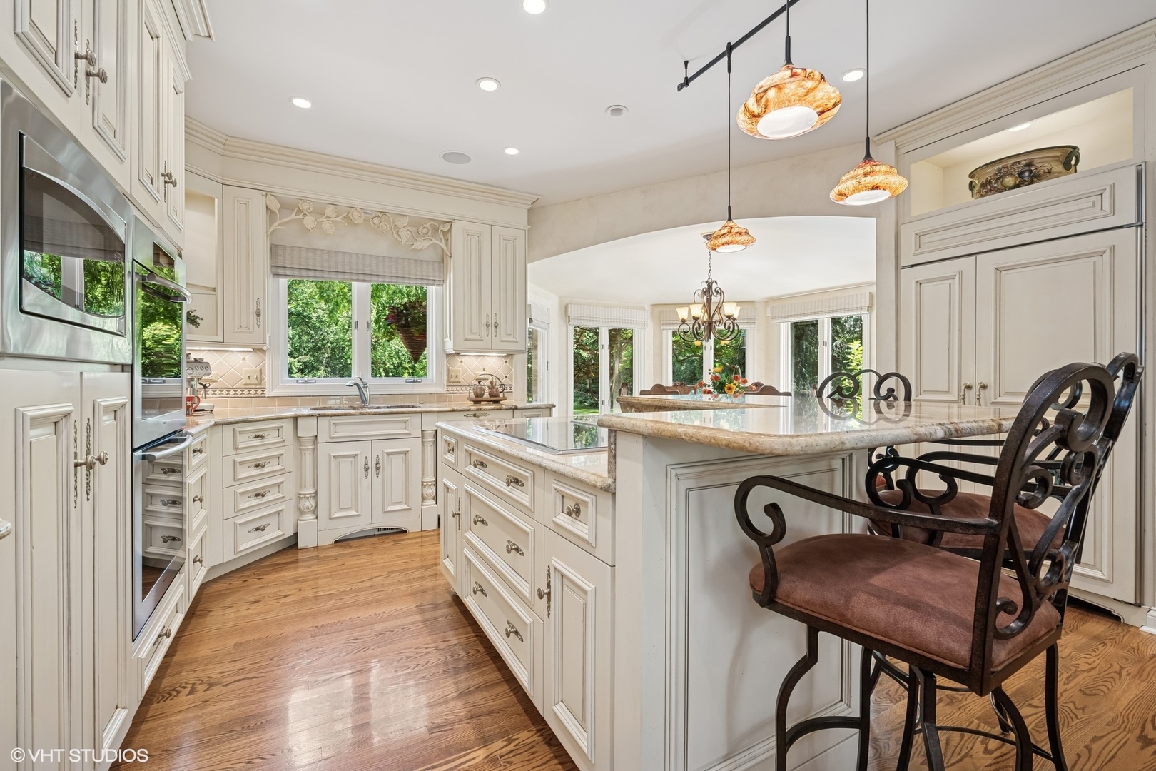 85 Ela Road Inverness, IL 60067 - Photo 11 of 89 a kitchen with stainless steel appliances kitchen island granite countertop a stove a sink and a dining table with wooden floor
