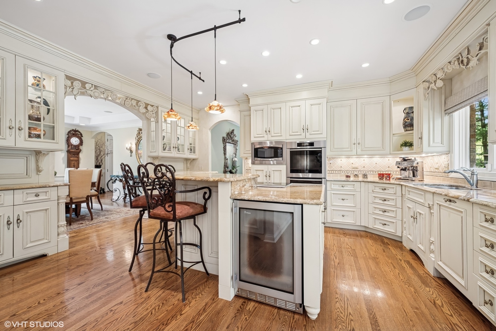 85 Ela Road Inverness, IL 60067 - Photo 12 of 89 a kitchen with stainless steel appliances kitchen island granite countertop a stove a sink dishwasher a refrigerator with white cabinets and wooden floor