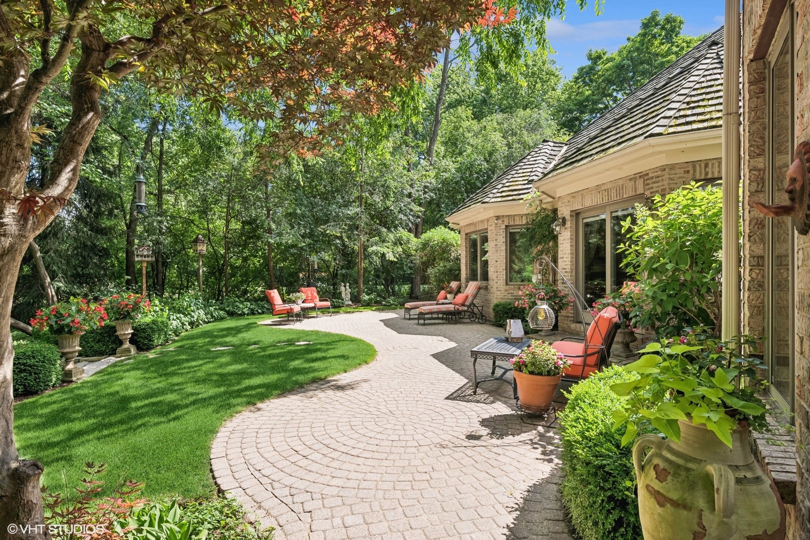 85 Ela Road Inverness, IL 60067 - Photo 67 of 89 a backyard of a house with fountain table and chairs