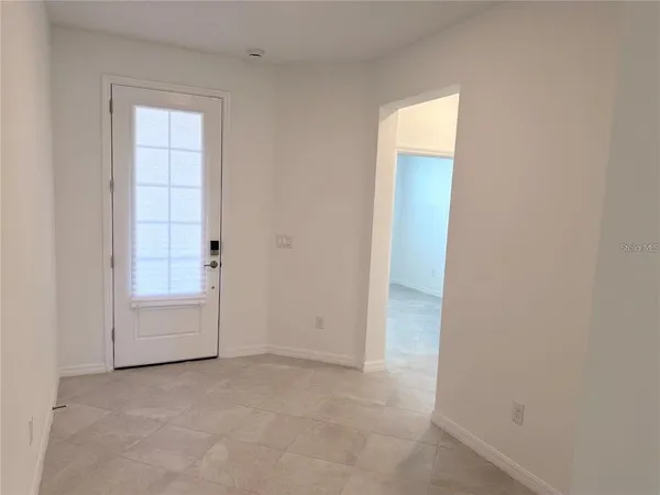 an empty room with a ceiling fan and bathroom