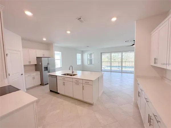 a kitchen with stainless steel appliances a refrigerator stove microwave and cabinets