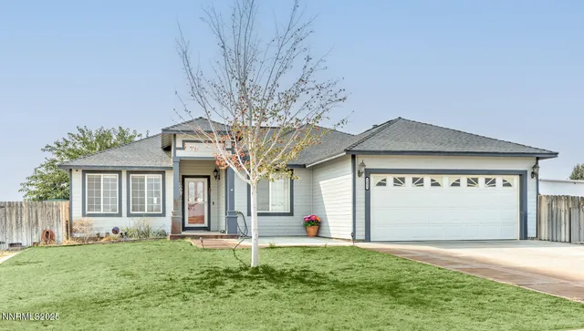 a front view of a house with a yard and garage