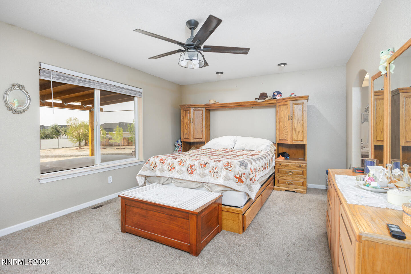 5655 Dillon Drive Fallon, NV 89406 - Photo 13 of 25 a bedroom with a bed a window and a chandelier
