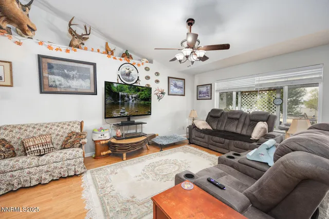a living room with furniture a fireplace and a flat screen tv