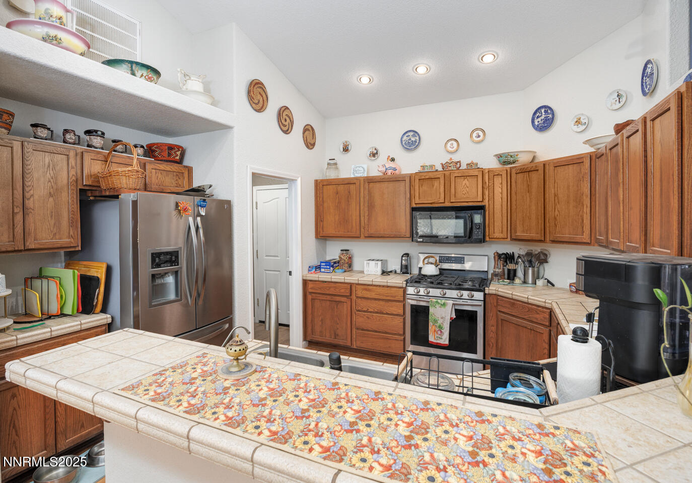 5655 Dillon Drive Fallon, NV 89406 - Photo 5 of 25 a kitchen with stainless steel appliances kitchen island granite countertop a refrigerator and a stove top oven