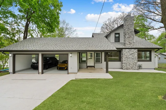a view of a house with a yard and sitting area