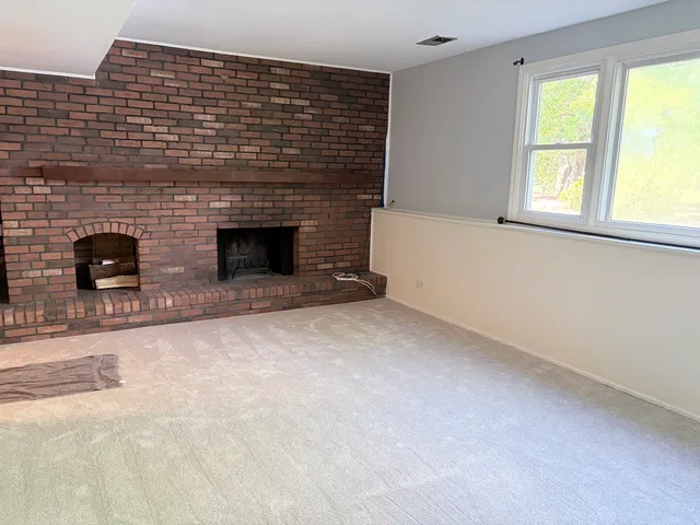 a view of empty room with a fireplace