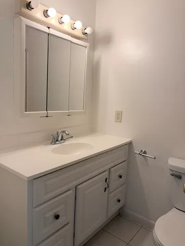 a bathroom with a sink vanity and mirror