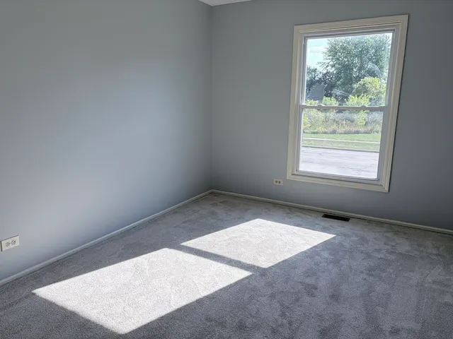an empty room with large window