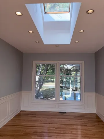 a view of a room with wooden floor and a window