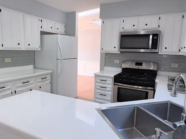 a kitchen with a refrigerator and a stove