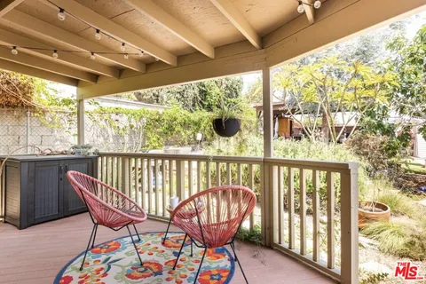 a view of a chair and table in the balcony