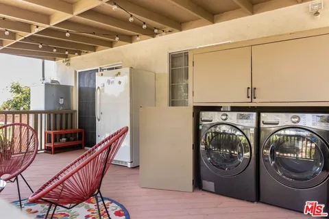 a view of a hallway with washer and dryer