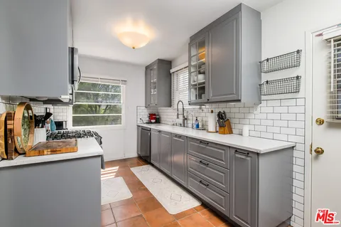 a kitchen with a sink stove and window