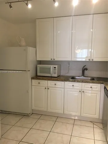 a kitchen with cabinets and appliances