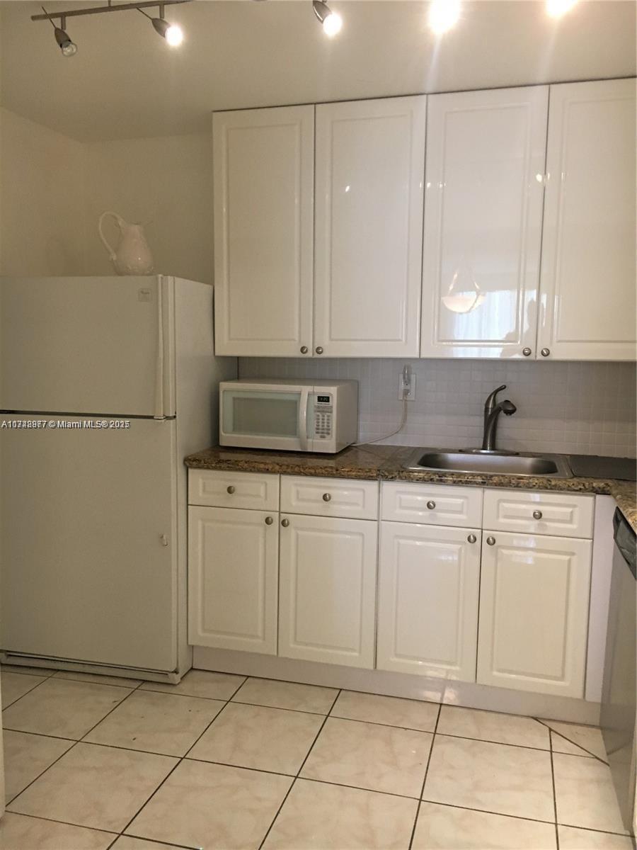 2750 Northeast 183rd Street, Unit 801 Aventura, FL 33160 - Photo 16 of 29 a kitchen with cabinets and appliances