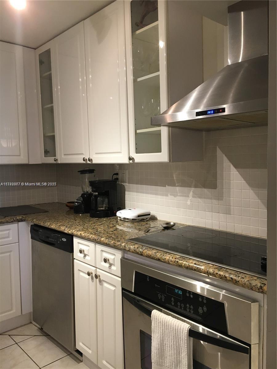 2750 Northeast 183rd Street, Unit 801 Aventura, FL 33160 - Photo 17 of 29 a kitchen with stainless steel appliances granite countertop a sink and a stove