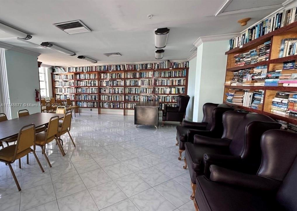 2750 Northeast 183rd Street, Unit 801 Aventura, FL 33160 - Photo 20 of 29 a livingroom with workspace and a couch