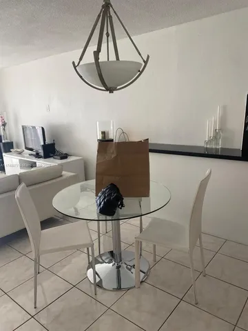 a living room with dining table and chairs