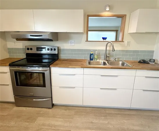 a kitchen with a stove and a sink