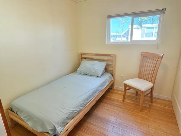 a bedroom with a bed and a chair