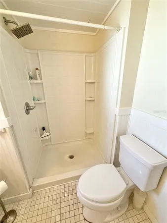 a bathroom with a toilet and a shower