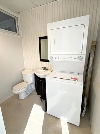 a bathroom with a sink toilet and mirror