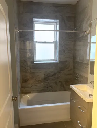 a bathroom with a bathtub and shower