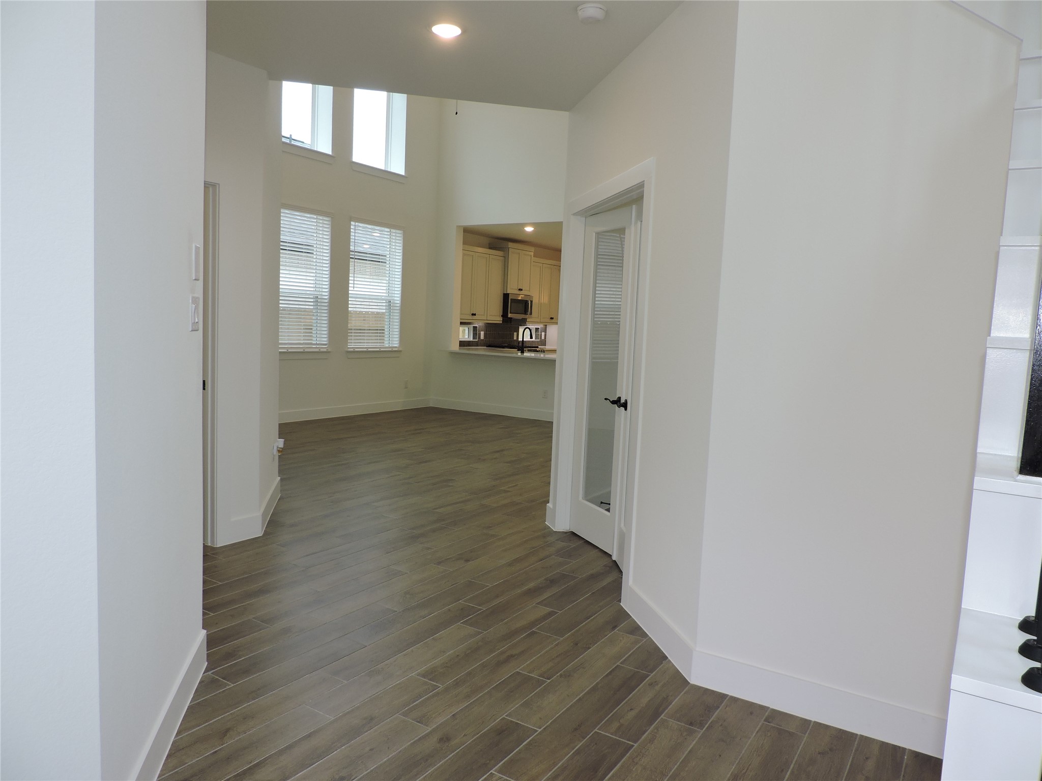 12853 Meadow Wind Way Conroe, TX 77302 - Photo 7 of 47 Across from the Home office leads to the garage, and the laundry. The Easy Care Wood Look Ceramic tile flooring
is throughout the downstairs.