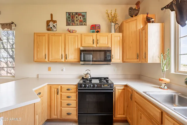 a kitchen with stainless steel appliances granite countertop a sink and cabinets