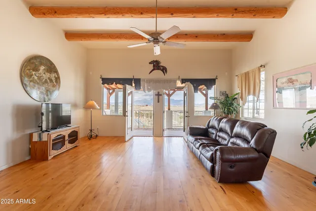 a living room with furniture a fireplace and wooden floor