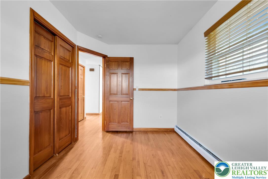 2118 6th Street Bethlehem, PA 18020 - Photo 15 of 40 a view of empty room with wooden floor and fan