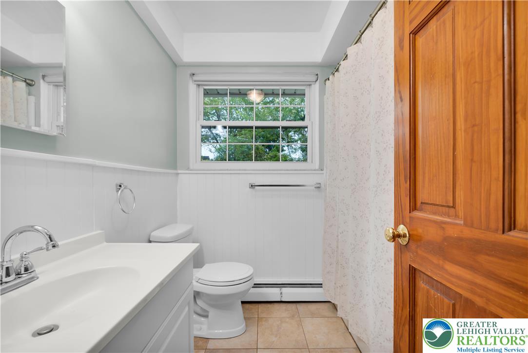2118 6th Street Bethlehem, PA 18020 - Photo 19 of 40 a bathroom with a toilet a sink and a window