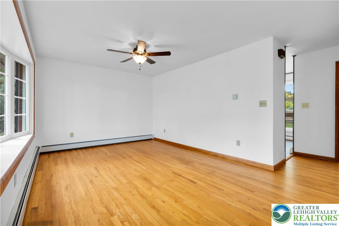 2118 6th Street Bethlehem, PA 18020 - Photo 5 of 40 a view of a room with wooden floor and a ceiling fan