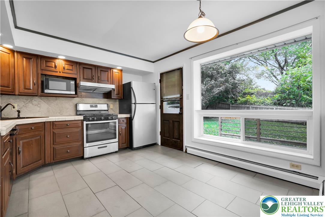 2118 6th Street Bethlehem, PA 18020 - Photo 6 of 40 a kitchen with a window a refrigerator and furniture